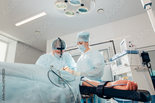 patient lies on the operating surgical table during rhinoplastic operation surgery with anesthesia photo