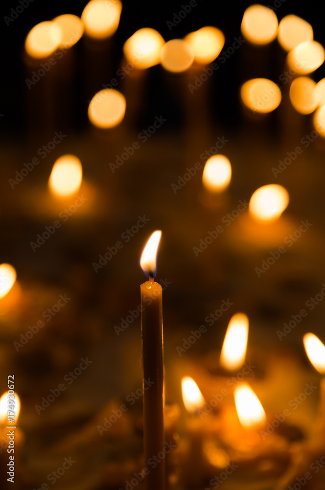 Slow burning wax candles in church as a symbol of death memory Slow burning wax candles in church as a symbol of death memory