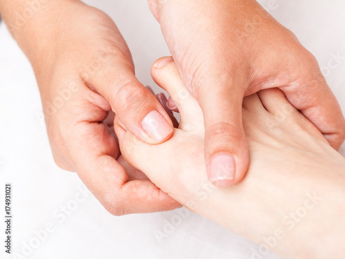 Woman receiving osteopathic treatment of her foot finger