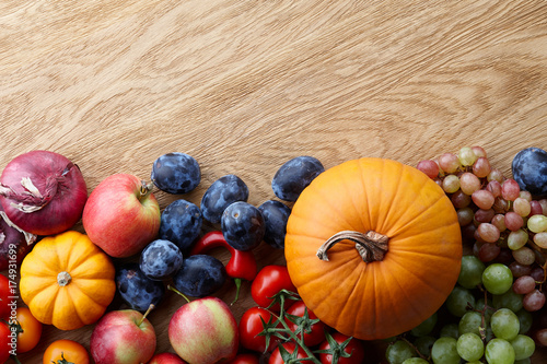 Fototapeta Naklejka Na Ścianę i Meble -  Autumn harvest concept. Seasonal fruits and vegetables on a wooden table, top view