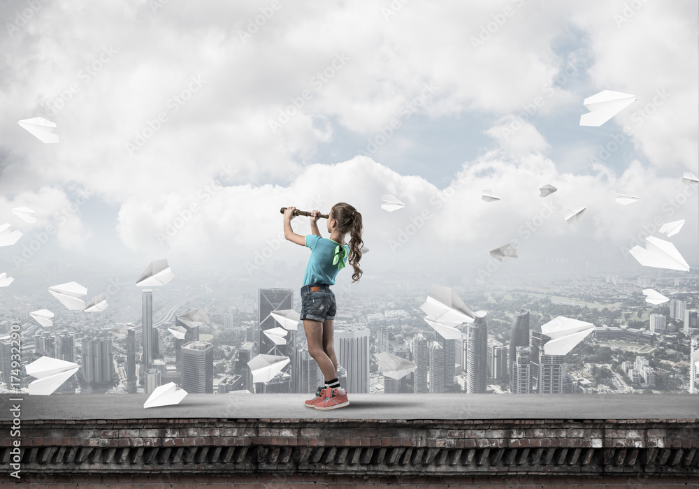 Concept of careless happy childhood with girl exploring this wor Concept of careless happy childhood with girl exploring this wor