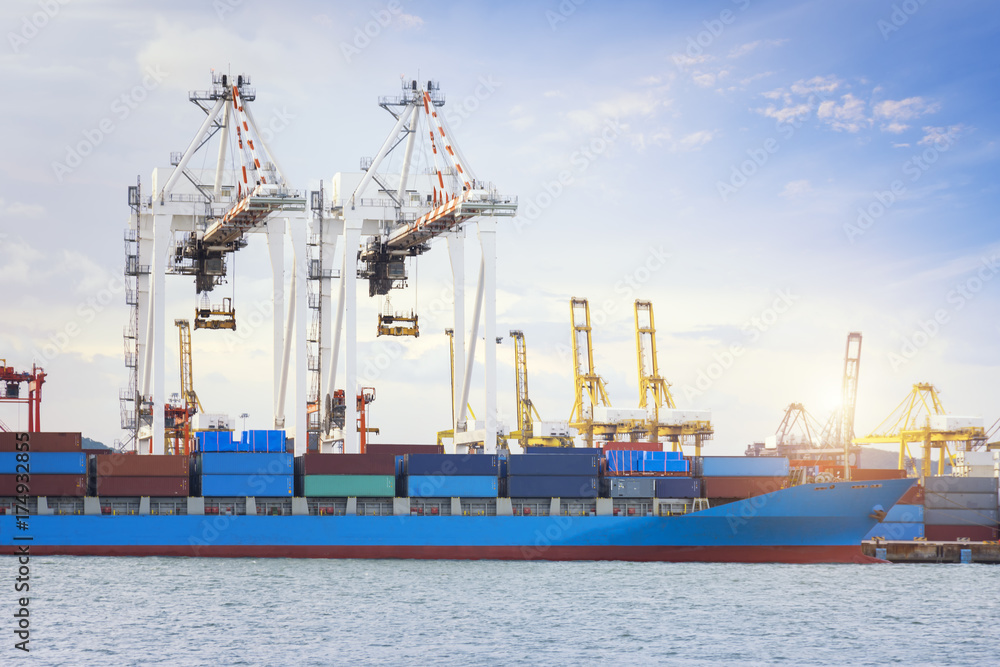 Container Cargo freight ship with working crane bridge in shipyard at dusk for Logistic Import Export background