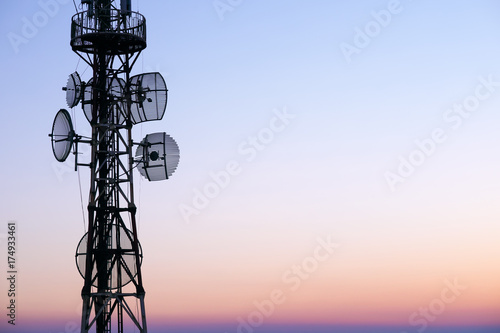 Telecommunication tower Antenna at sunset sky. photo