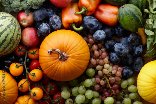 Autumn harvest concept. Seasonal fruits and vegetables on a wooden table, top view