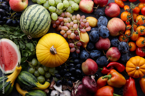 Fototapeta Naklejka Na Ścianę i Meble -  Autumn harvest concept. Seasonal fruits and vegetables on a stone tabletop, top view