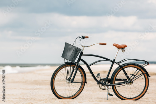 Pretty bicycle parked on beach. Retro bike near the sea
