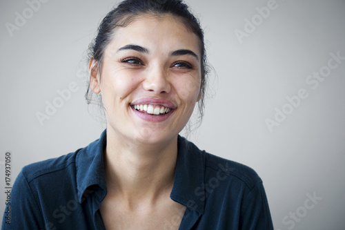 Young woman happy on gray background