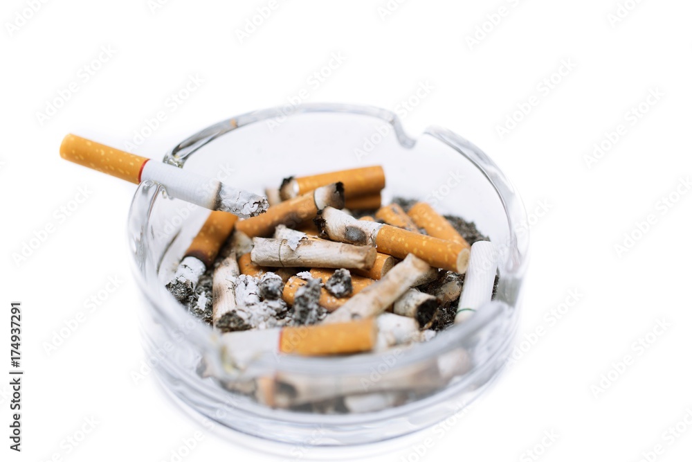 smoking a cigarette on ashtray in white background. smoking a cigarette on ashtray in white background.