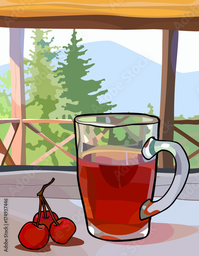 glass cup with tea and berries on a window sill