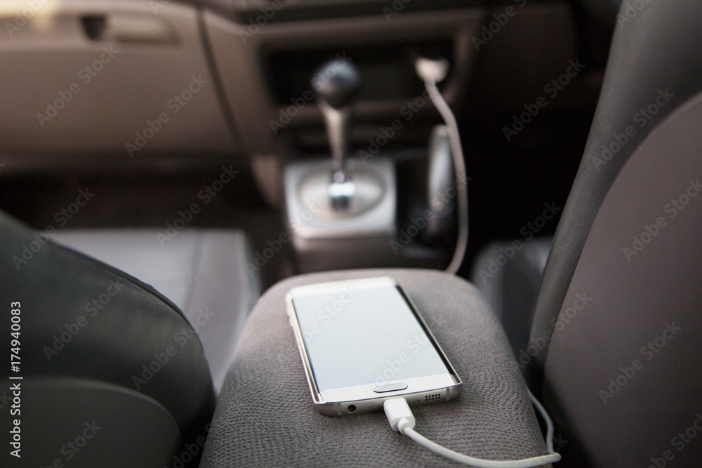 Charger plug phone on car.  Concept While charging, do should not use the phone may cause danger.