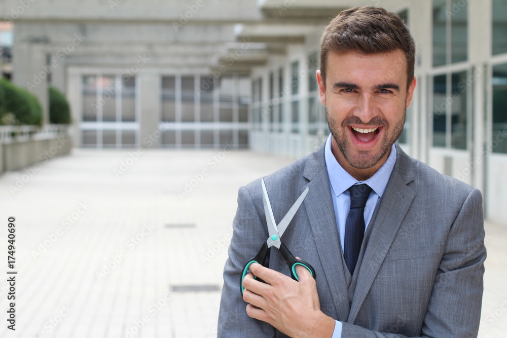 Businessman holding a pair of scissors Businessman holding a pair of scissors