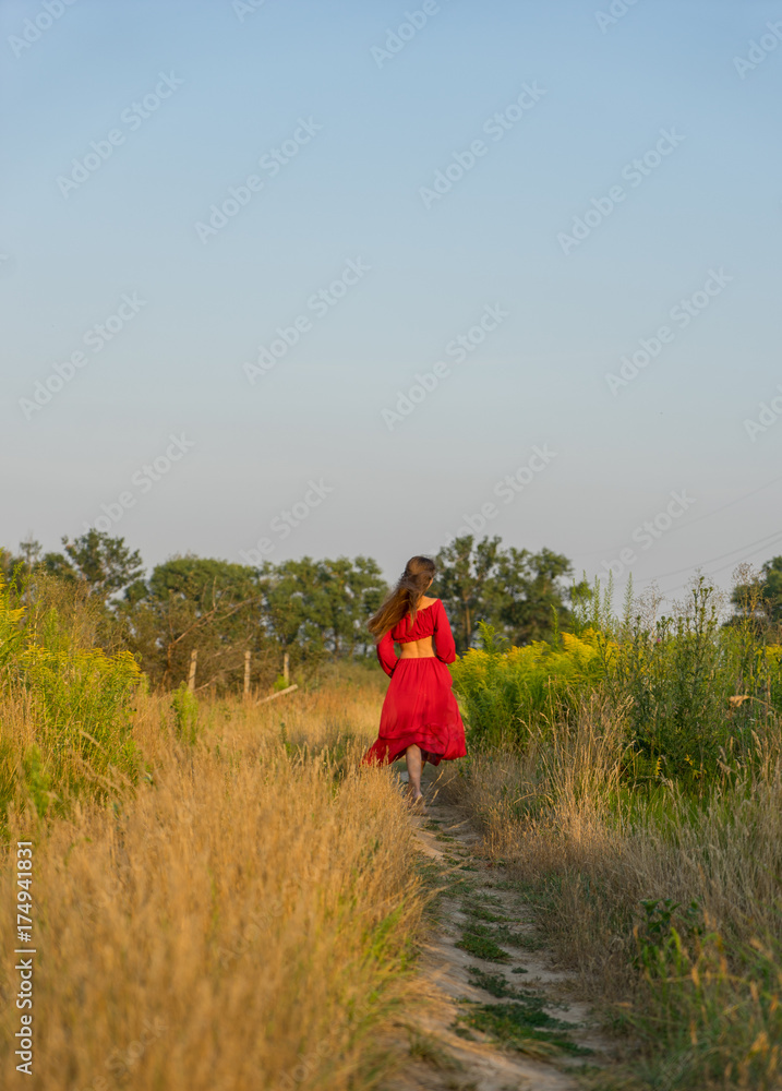 cheerful rural girl in red dress. cheerful rural girl in red dress.