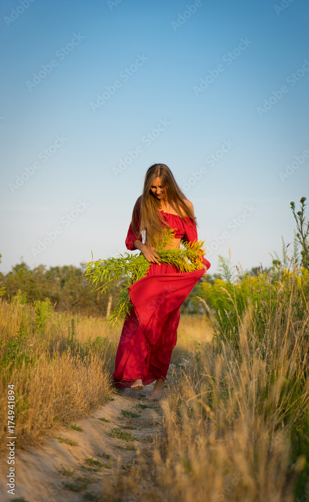Obraz premium cheerful rural girl in red dress.