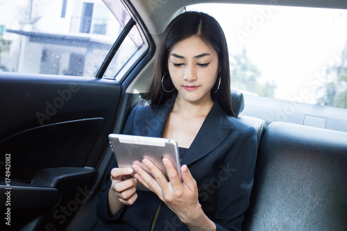 Woman using Smartphone for working in car, Woman working concept. © Bavorndej