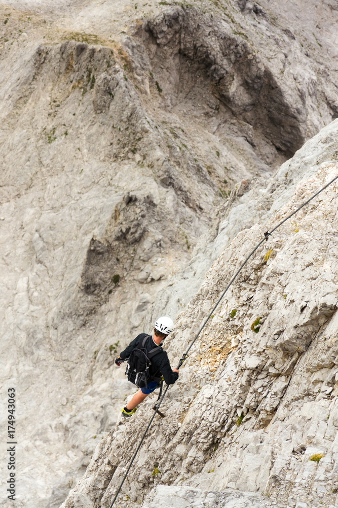 People climbing on via ferrata to Dachstein glacier, Austrian Alps