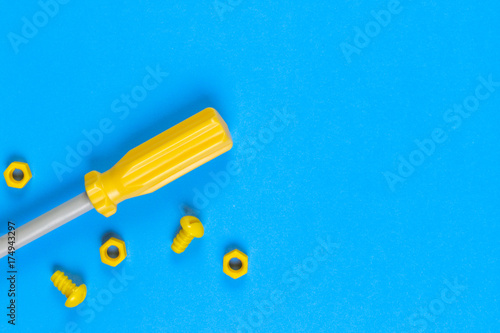 Toys background. Kids construction toys tools on light blue and yellow background.