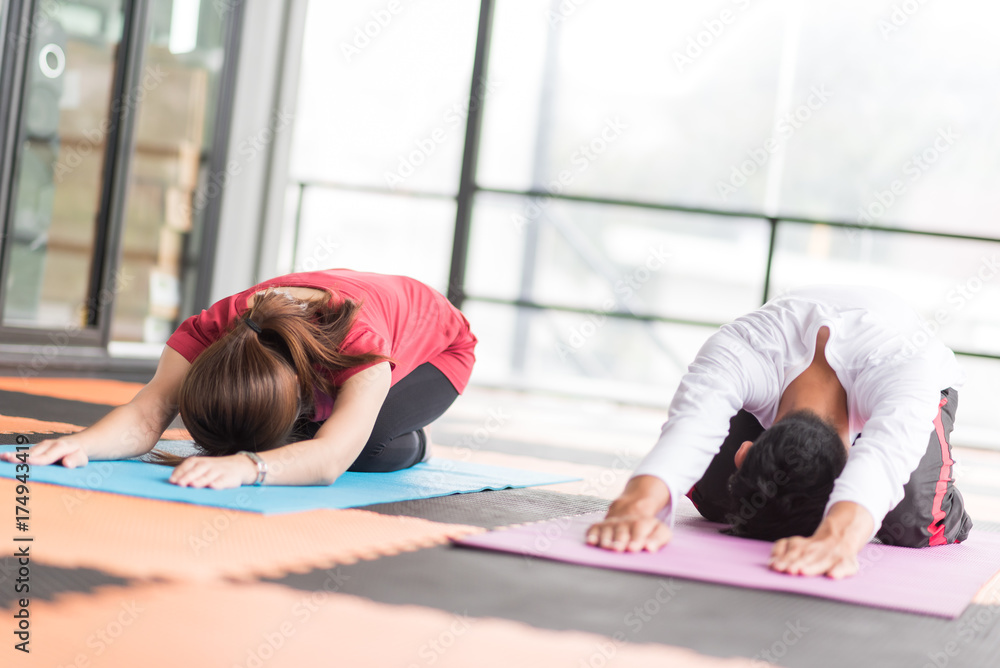 Obraz premium Group of people doing yoga in the class