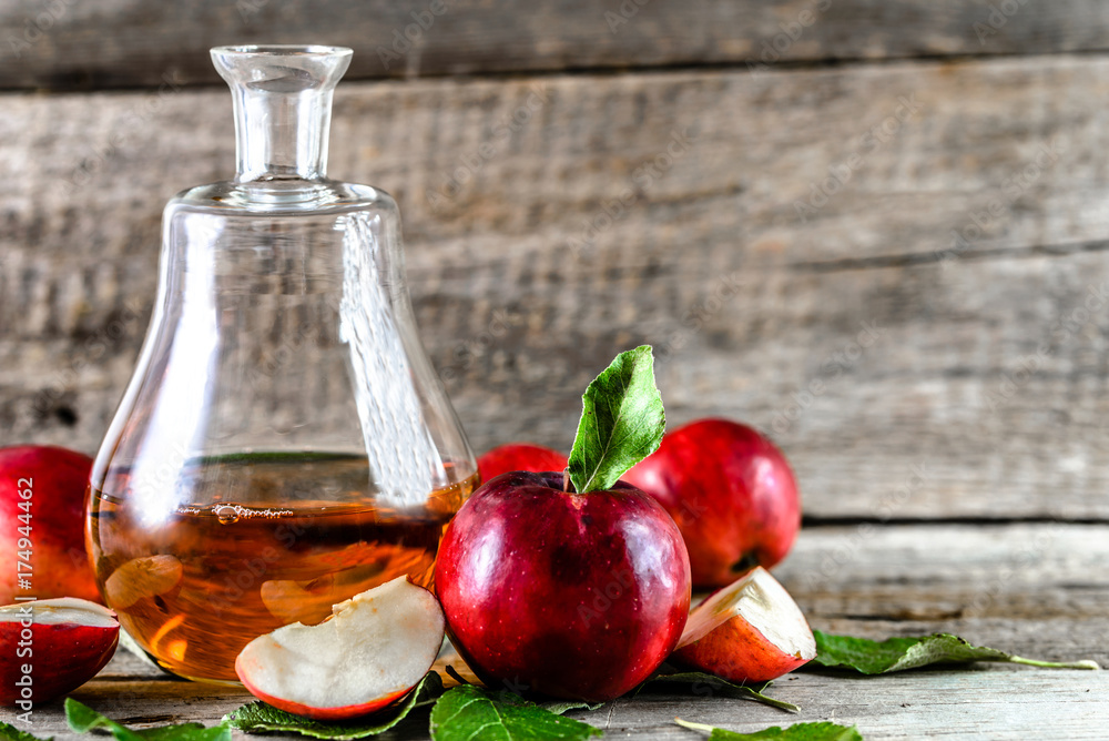 Apple vinegar or cider, bottle of drink and fresh apples, healthy organic food concept Apple vinegar or cider, bottle of drink and fresh apples, healthy organic food concept