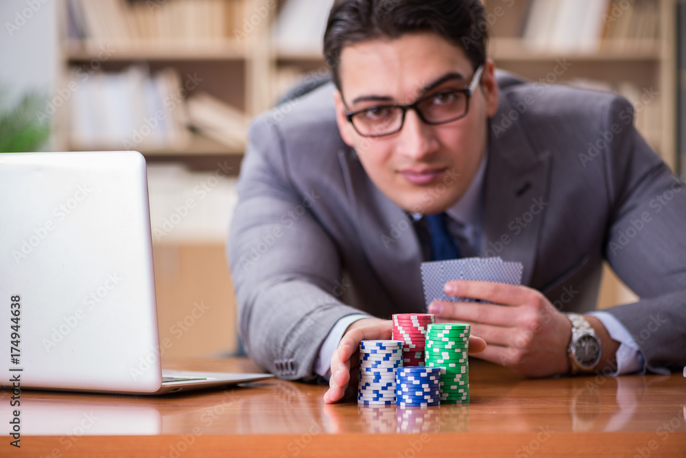Businessman gambling playing cards at work Businessman gambling playing cards at work