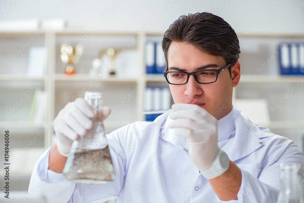 Young researcher scientist doing a water test contamination expe Young researcher scientist doing a water test contamination expe