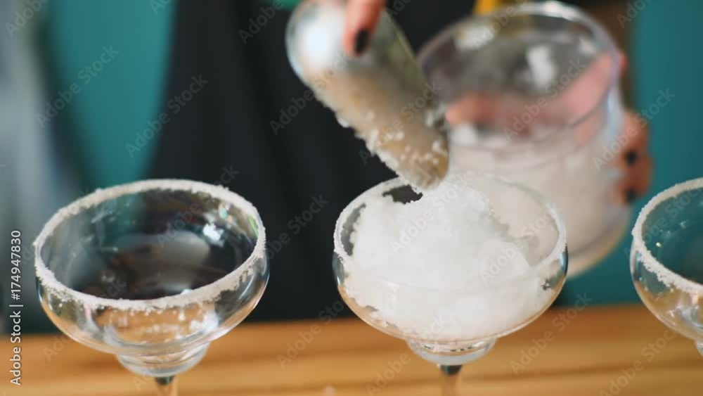 Barmaid making cocktail closeup woman empty glass granulated blender ice cubes cold freeze water frost table beverage process alcohol cool crystal iced cafe bar drink spoon refreshing summer party Barmaid making cocktail closeup woman empty glass granulated blender ice cubes cold freeze water frost table beverage process alcohol cool crystal iced cafe bar drink spoon refreshing summer party