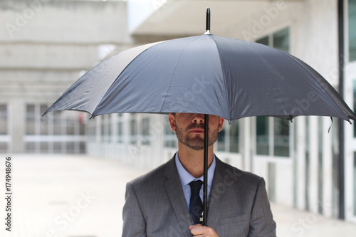 Wallpaper Mural Businessman hiding under an umbrella in office space Torontodigital.ca