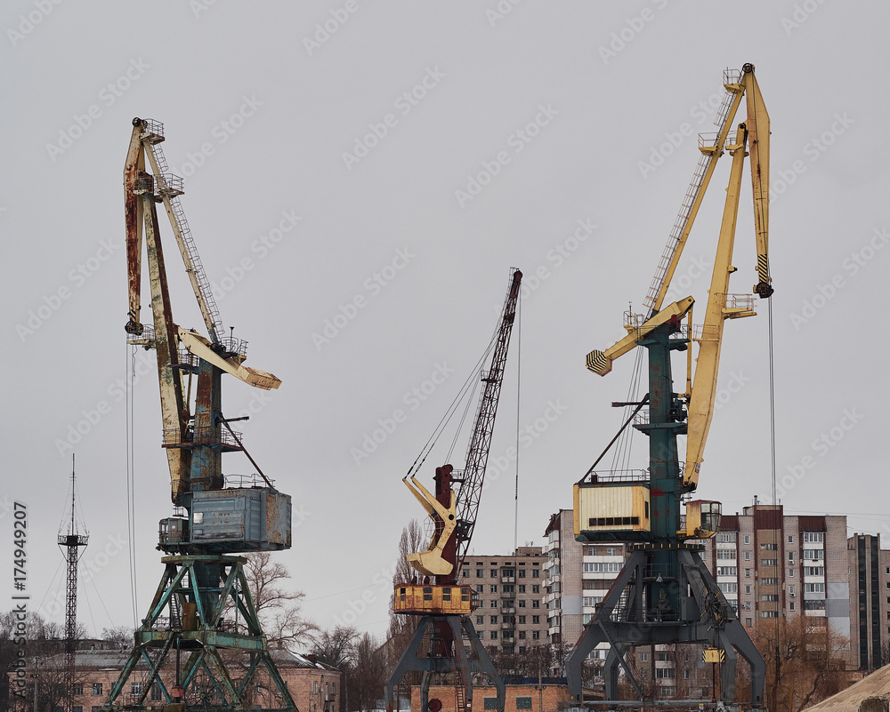Old harbor cranes standing in the port