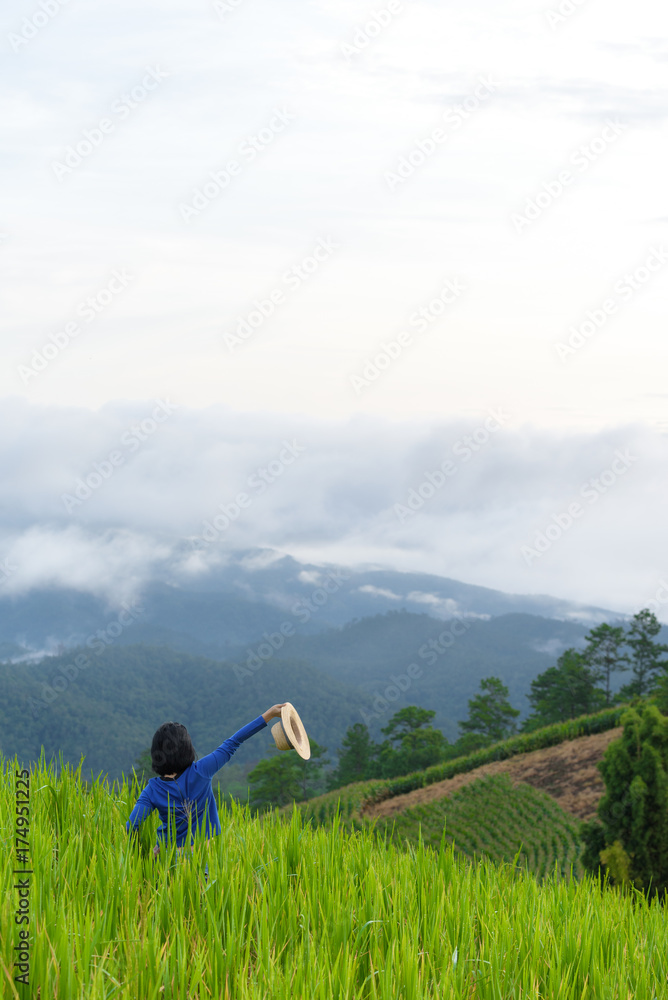Happy woman enjoy view of rice field and landscape of mountain area in Chiangmai northern Thailand Happy woman enjoy view of rice field and landscape of mountain area in Chiangmai northern Thailand