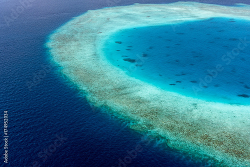 Colorful aerial photo of Maldives atolls and deep blue sea