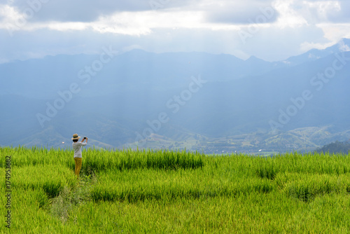 Woman enjoy view of rice field and landscape of mountain area in Chiangmai northern Thailand