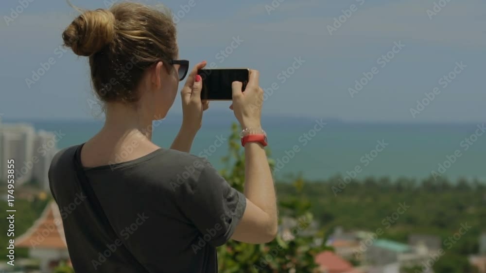 Tourist taking travel picture with phone during summer holidays. Unrecognizable female young adult enjoying in Asia. Tourist taking travel picture with phone during summer holidays. Unrecognizable female young adult enjoying in Asia.