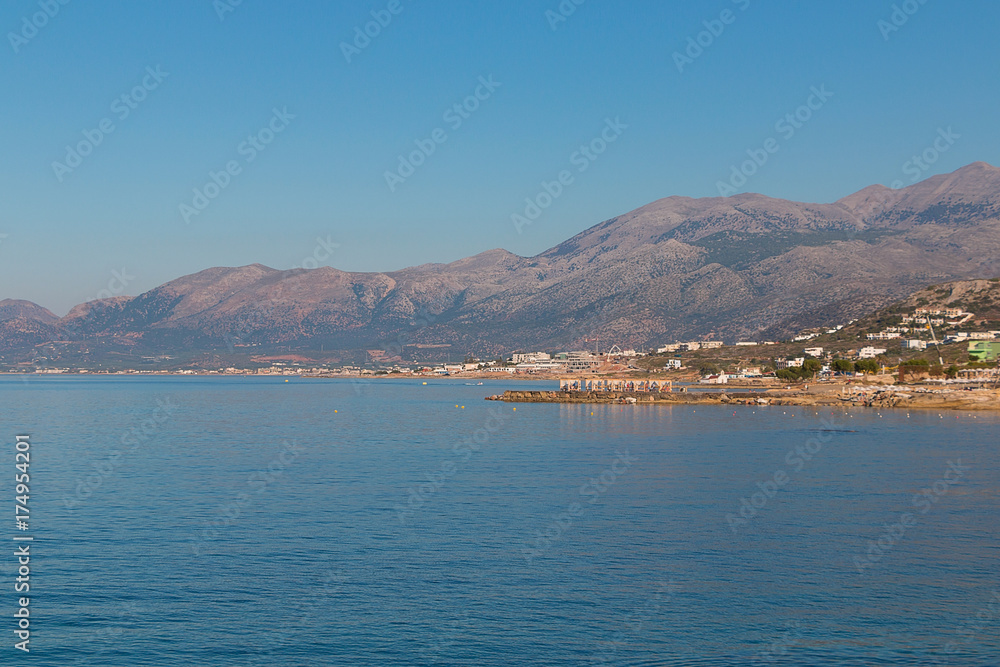 Greek coast, mountains, sea, sky, sun.