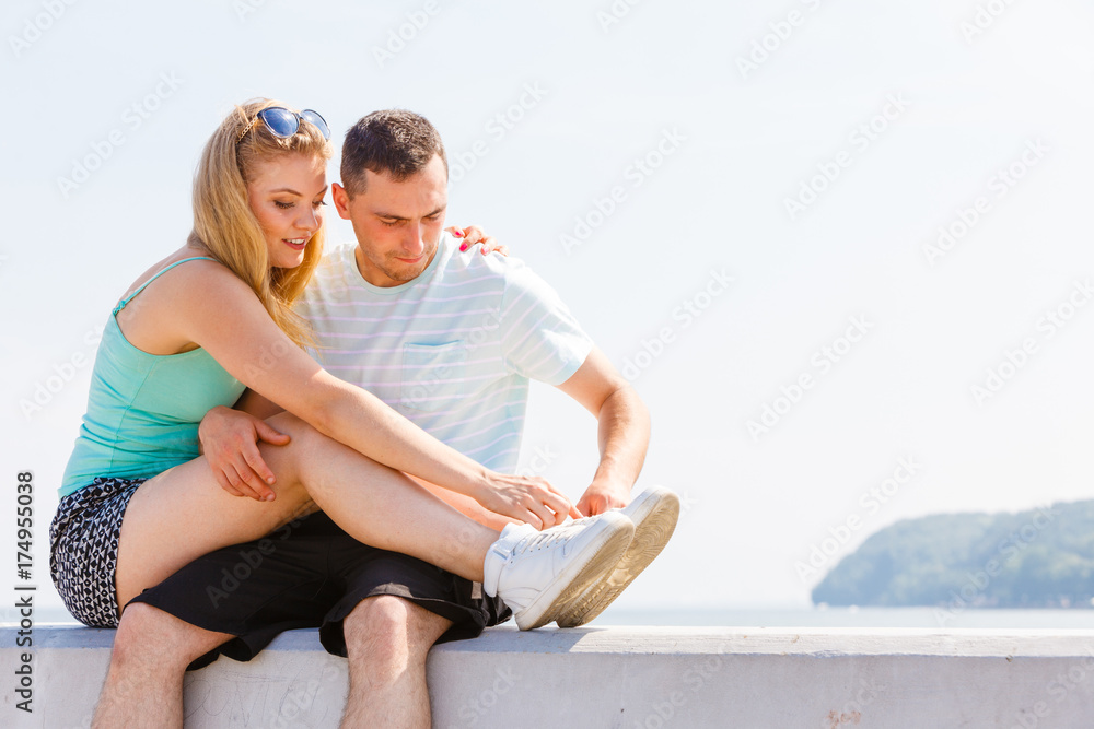 Man and woman sitting together outside