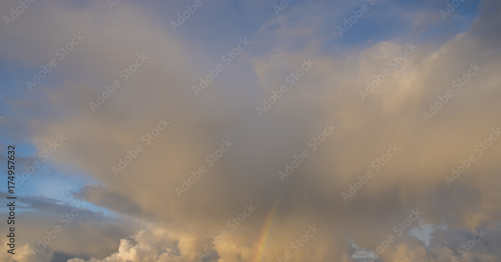 stormy sky with colorful rainbow