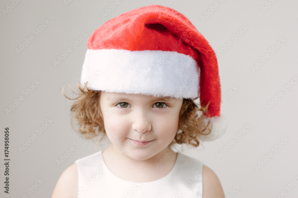 funny little curly blonde girl in a Santa hat funny little curly blonde girl in a Santa hat
