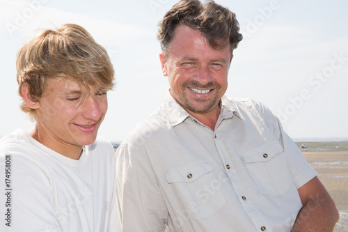 happy father with teenager boy son outdoor in holidays