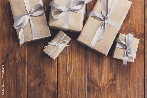 Presents in gift boxes on wood frame background