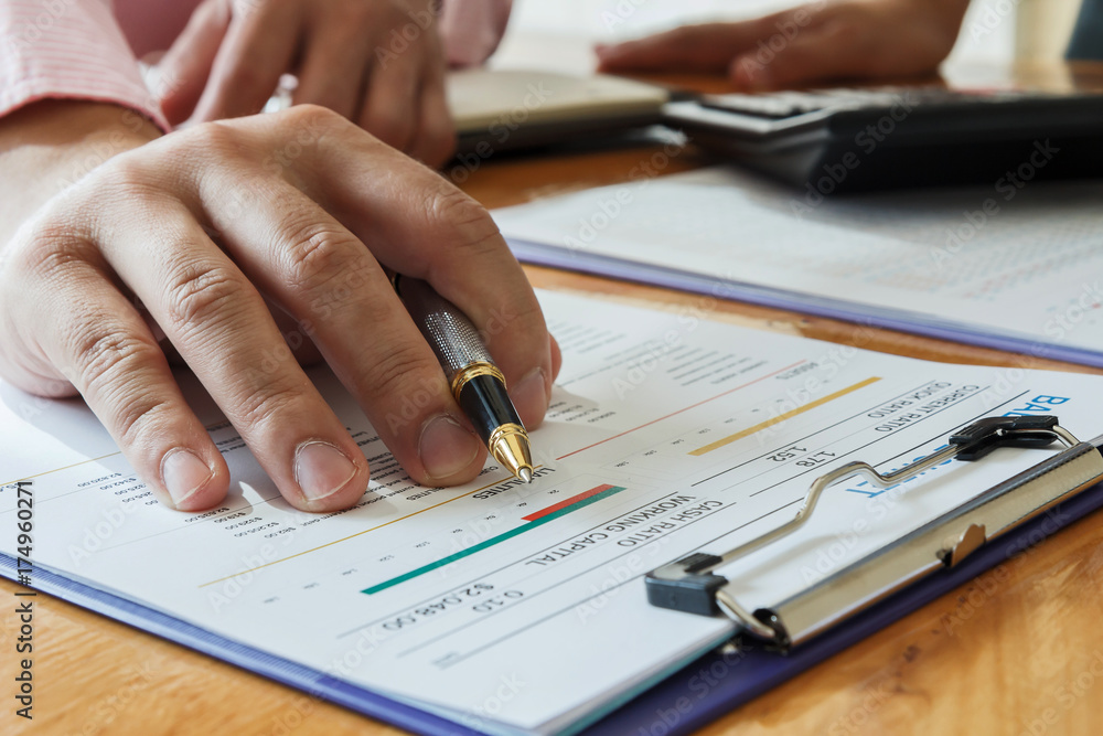 Businessman writing or pointing on report paper. Business strategy concept. Businessman writing or pointing on report paper. Business strategy concept.