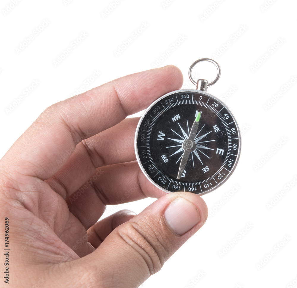 Hand holding black compass isolated on white background Hand holding black compass isolated on white background