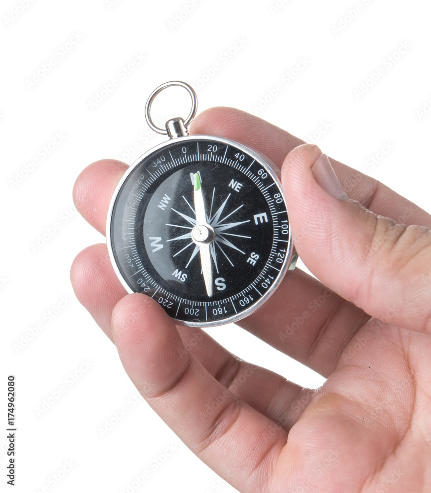 Hand holding black compass isolated on white background Hand holding black compass isolated on white background