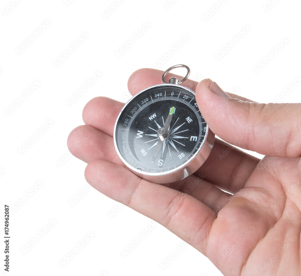 Hand holding black compass isolated on white background Hand holding black compass isolated on white background