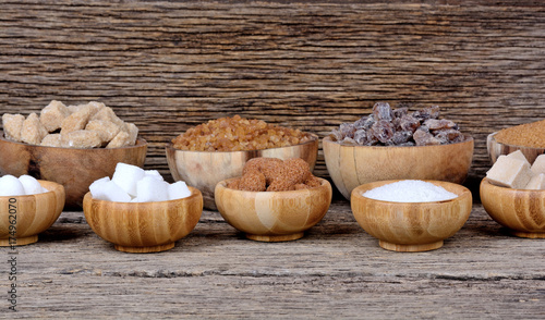 Different types of sugar in a many bowls on table