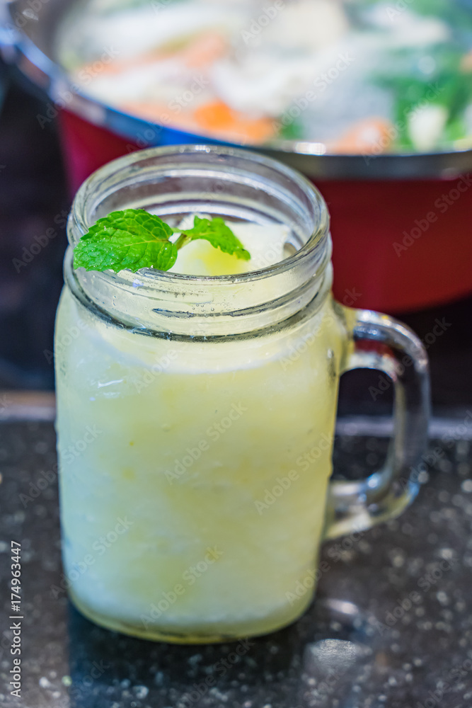 Glass of lemon lime blended summer drink with mint topping Glass of lemon lime blended summer drink with mint topping