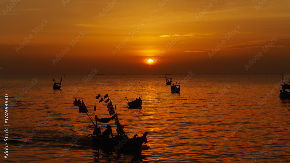 sunset on the sea with small boat fishing at Bangsan, Chonburi, Thailand.
