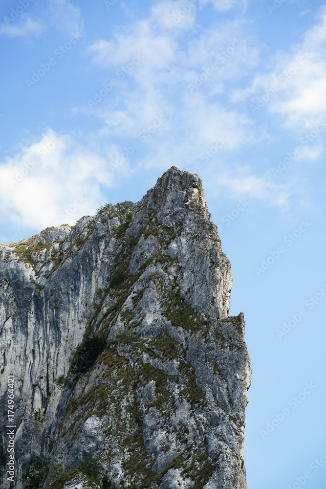 High rocky mountain over blue sky