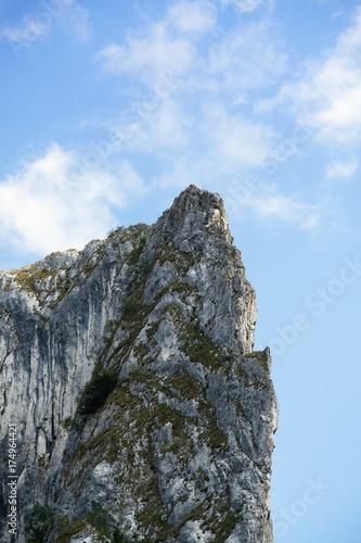 High rocky mountain over blue sky