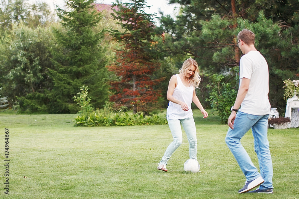 Happy family playing ball in his garden