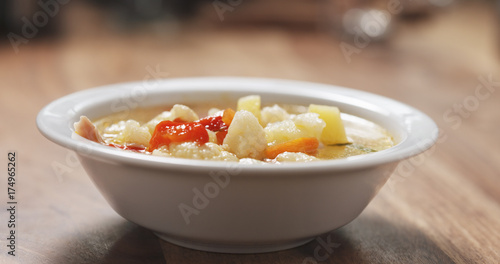 cauliflower soup in bowl on wood table