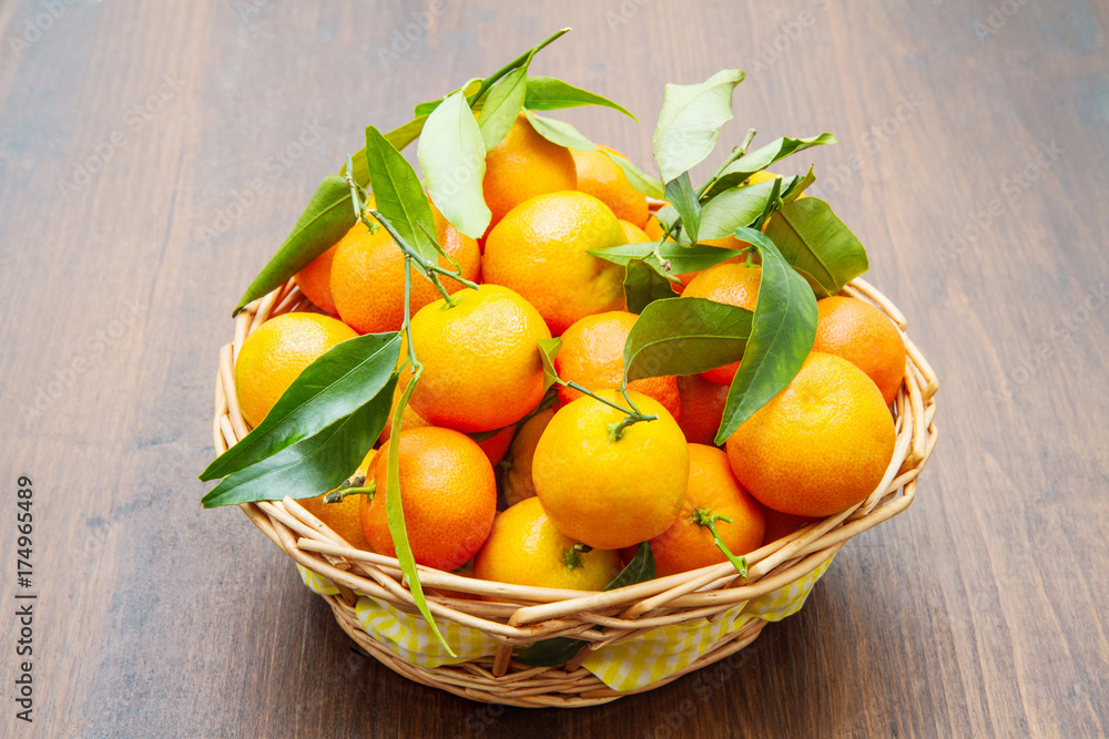 fresh mandarin oranges fruit with leaves on wooden table