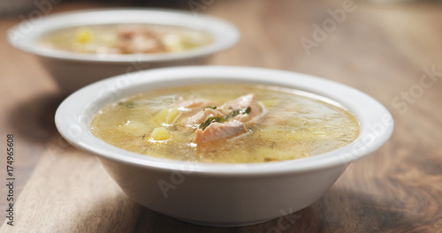closeup fish soup with salmon on wood table